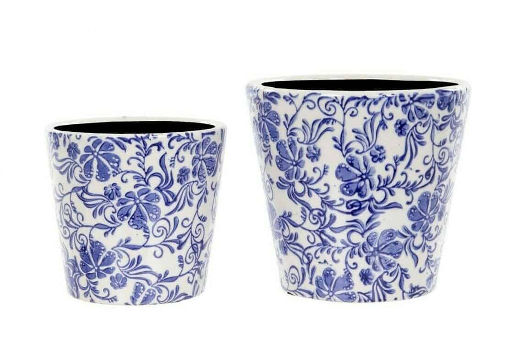Two differently sized flower pots in white with blue floral patten. Situated on a white studio background
