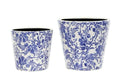Two differently sized flower pots in white with blue floral patten. Situated on a white studio background