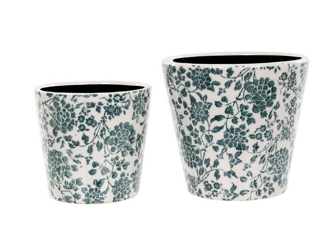 Two ceramic planters of medium and large size featuring intricate floral design of green. Situated on a white studio background