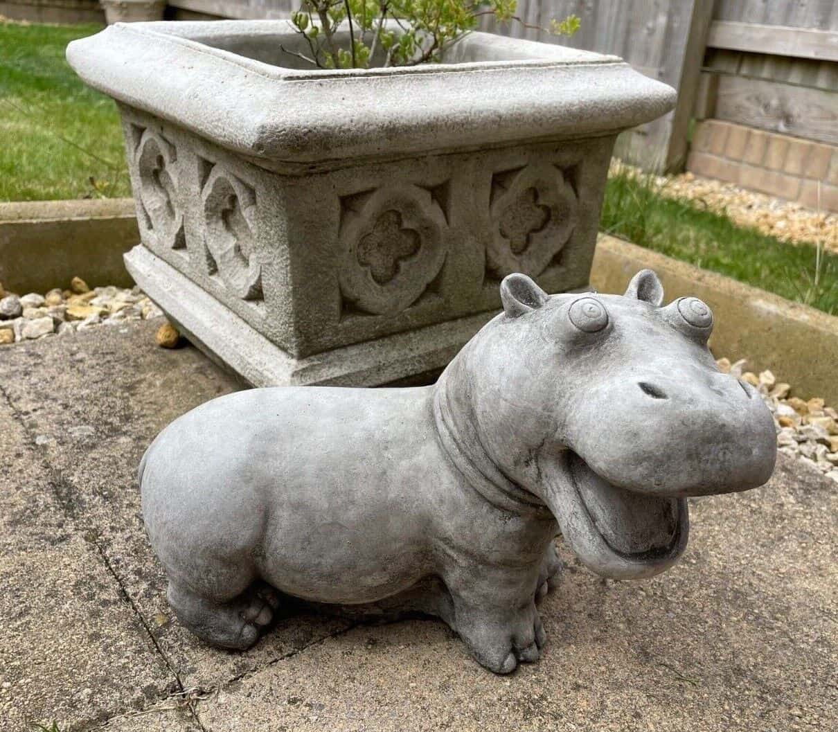 A hippopotamus standing on the patio of a British garden