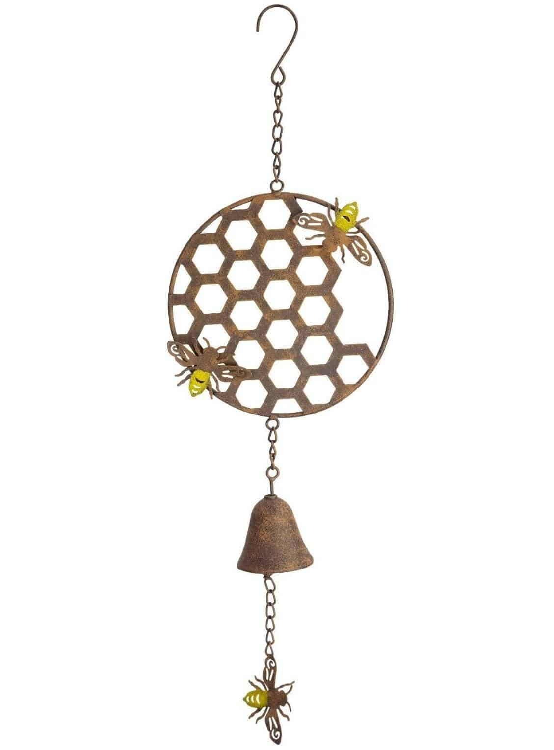 A bell hangs down from the beautiful honeycomb adorned with bumble bees. In beautiful tones of sunshine yellow & russet, situated on a white studio background