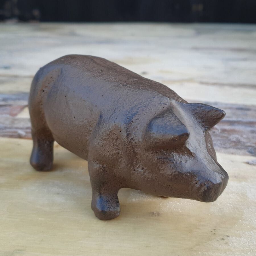 A Pig with faded cast iron finish situated on the floor of a British home.